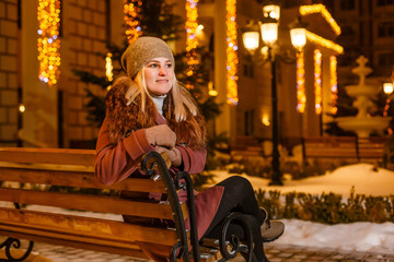 Smiling winter woman in night city