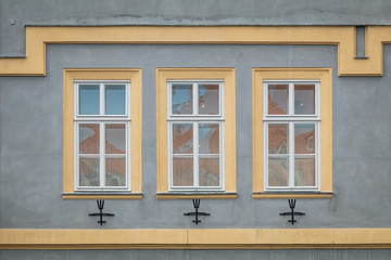 Grey facade of the old house. The Windows and decoration of walls in Litomerice, Czechia
