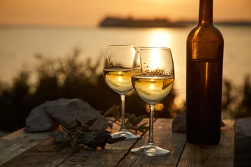 Poster two glasses with wine during sunset time © fox17
