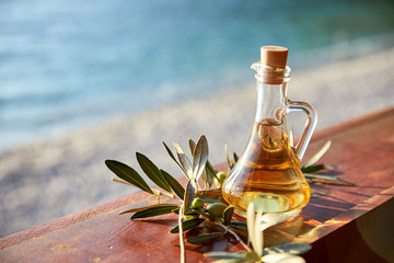 olive oil with fresh olives and leaves