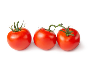 Several tomatoes on a white isolated background. Fresh vegetables.