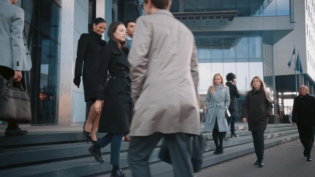 Diverse and Multicultural Office Managers and Business People Commute to Work in the Morning or from Office on a Sunny Day on Foot. Female and Male are Talking and Smiling on Their Way from Office. 