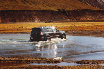 car on the river in iceland