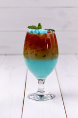 blue cocktail with marshmallow and mint