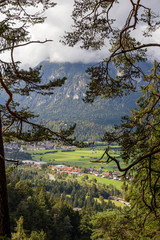 cloudy view on village through trees