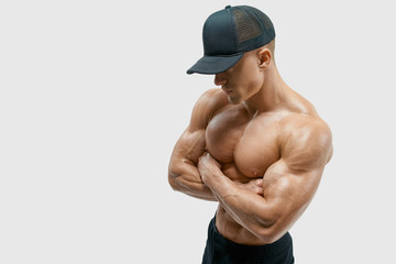 Shot of healthy muscular young man with black beseball cap. Perfect fit, six pack, abs, abdominal...