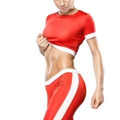 Close-up fitness athletic young woman in red sportswear showing her well trained body, six pack,...