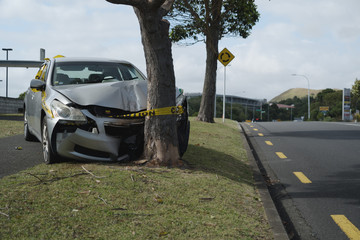 Silver sedan car crashed into a tree.