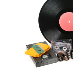 Vinyl record, video and audio cassettes isolated on white background. Free space for text.