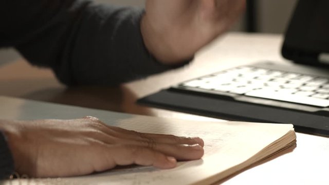 Latin woman writing in notebook