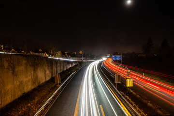Fototapeta na wymiar traffic in city on german highway at night in erlangen