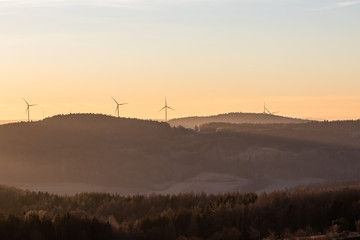 Fototapeta na wymiar wind turbines at sunrise franconian switzerland