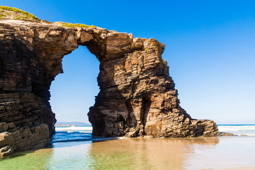 Fototapeta na wymiar Wonderful stone figures. Eroded beach coastline. Cathedrals beach at the Atlantic Ocean, Cantabric coast Lugo, Galicia, Spain - Playa de las Catedrales.