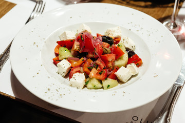 served table in the restaurant for a banquet with appetizers, salads and wine