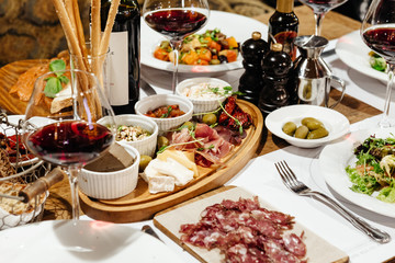 served table in the restaurant for a banquet with appetizers, salads and wine