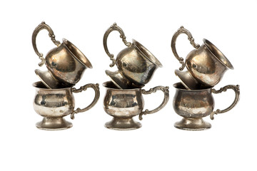 Set of silver dishes for tea or coffee Isolated on a white background. Silver tea or coffee set of utensils on a white background.