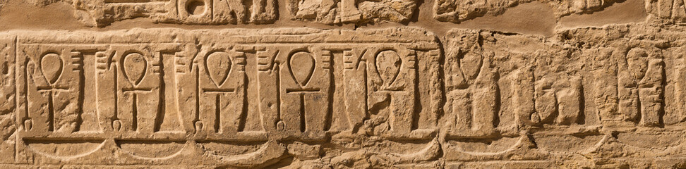 Karnak Temple, complex of Amun-Re. Embossed hieroglyphics on walls. Luxor Governorate, Egypt.
