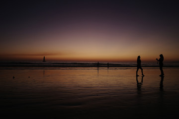 Fototapeta premium People on the beach at sunset. 