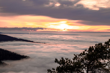 sunset landscape above clouds and fog