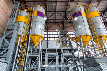 a plant for the production and mixing of concrete mortar with containers for cement and sand for...