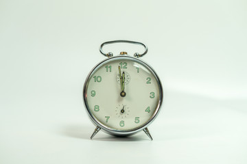 Fototapeta premium old metal analog clock isolated on White background