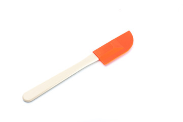 Orange spatula on white background