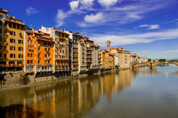 View to embankment of Arno river with bridge and medieval buildings, Florence, Italy.