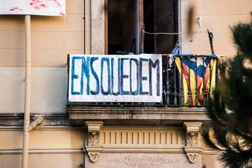Obraz premium Residential building is occupied by unauthorized squatters and transformed into illegal squat. Anarchist hand-written banner from the window.