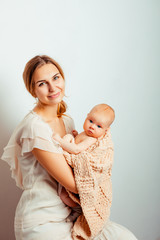 happy mother with her baby. young mother holds in her arms her newborn baby