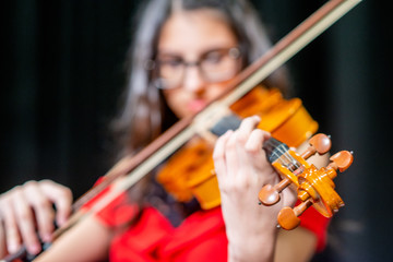A young girl playing the violin