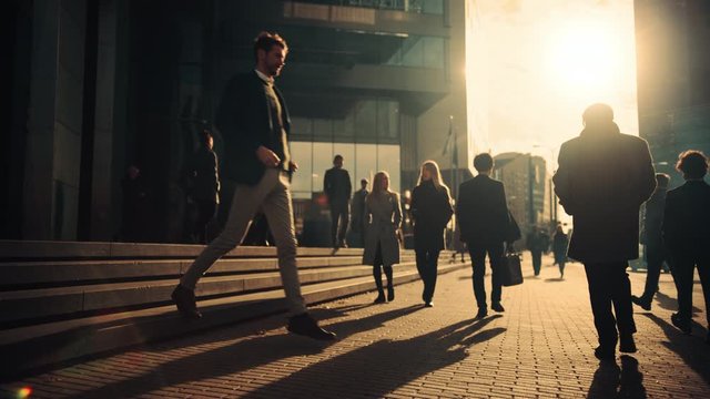 Office Managers and Business People Commute to Work in the Morning or from Office on a Sunny Day on Foot. Pedestrians are Dressed Smartly. Successful People Walking in Downtown. Cloudy Day in Downtown