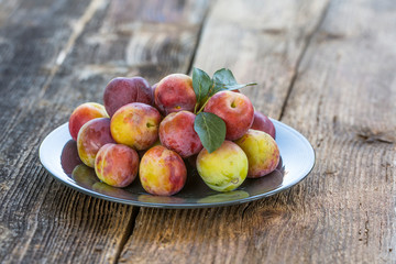 Sweet plums on wooden background