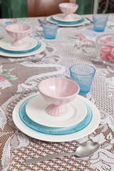 Modern blue and white dishes with bowl and glass in blue glass in the dining room.