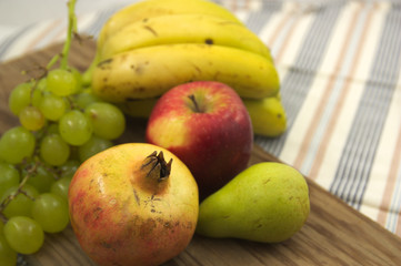 Assorted fruits on a wooden board