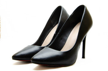 Women's shoes in black with a red sole on a white background. Shoes for the holiday, office shoes. High-heeled shoes, stilettos. Women's shoes close-up.