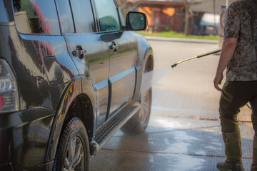 Washing car with soap. Close up concept.