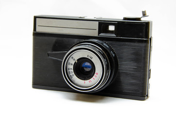 Old film camera. Rarity camera on a white background. A camera in muse hands, cocking. Soviet photographic equipment. The camera in macro, lens, inside, details