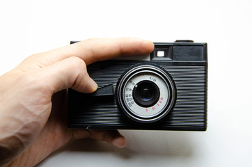 Old film camera. Rarity camera on a white background. A camera in muse hands, cocking. Soviet...