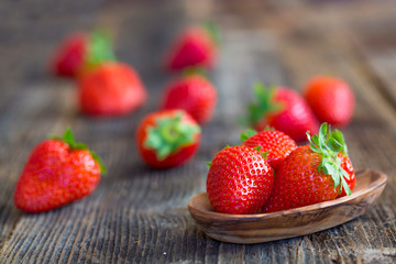 Strawberries in wooden bowl. Fresh nice strawberries on wooden table.