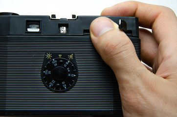 Old film camera. Rarity camera on a white background. A camera in muse hands, cocking. Soviet...