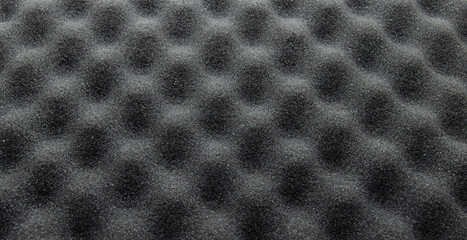 Foam rubber. Professional soundproofing for audio and video recording studios. Soundproof paralon on a white background, in macro. Soundproofing texture background for studio