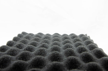 Foam rubber. Professional soundproofing for audio and video recording studios. Soundproof paralon on a white background, in macro. Soundproofing texture background for studio