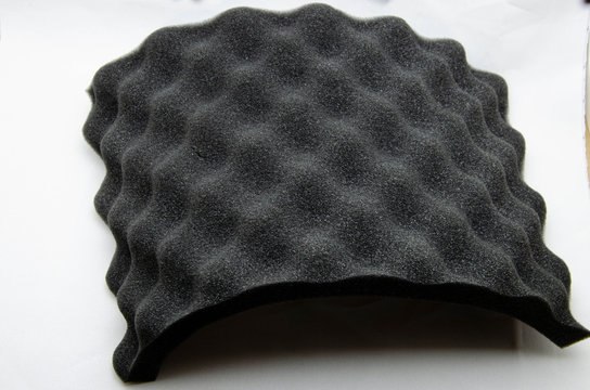 Foam rubber. Professional soundproofing for audio and video recording studios. Soundproof paralon on a white background, in macro. Soundproofing texture background for studio