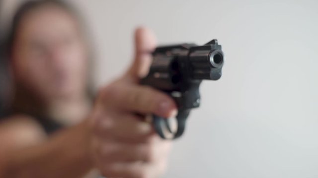 A man points a gun and prepares to shoot