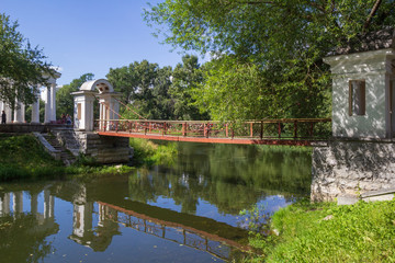 Fototapeta na wymiar Rotunda and bridge over the pond in Kharitonov historic park, Yekaterinburg