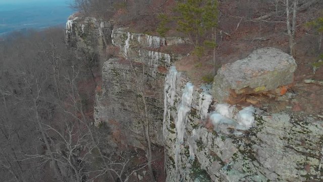 Aerial of Icicles on Rock Bluffs in Wilderness