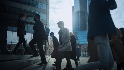 Office Managers and Business People Commute to Work in the Morning or from Office on a Sunny Day on Foot. Pedestrians are Dressed Smartly. Successful People Holding Smartphones. Day in Downtown. - Powered by Adobe