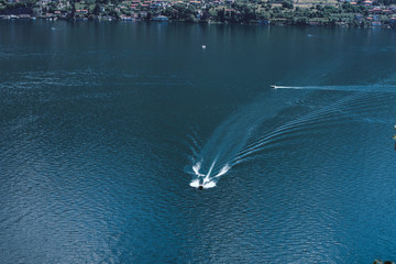 Boat floats at lake. Expensive boat floats on lake como