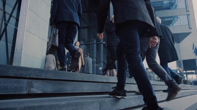 Office Managers and Business People Commute to Work in the Morning or from Office on a Sunny Day on Foot. Pedestrians are Dressed Smartly. Successful People Holding Smartphones. Slow Motion Footage.