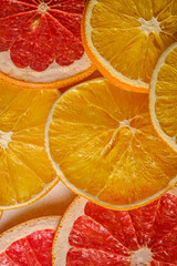 Fototapeta na wymiar Creative food fruit texture with dried grapefruit, orange and lemon macro, top view